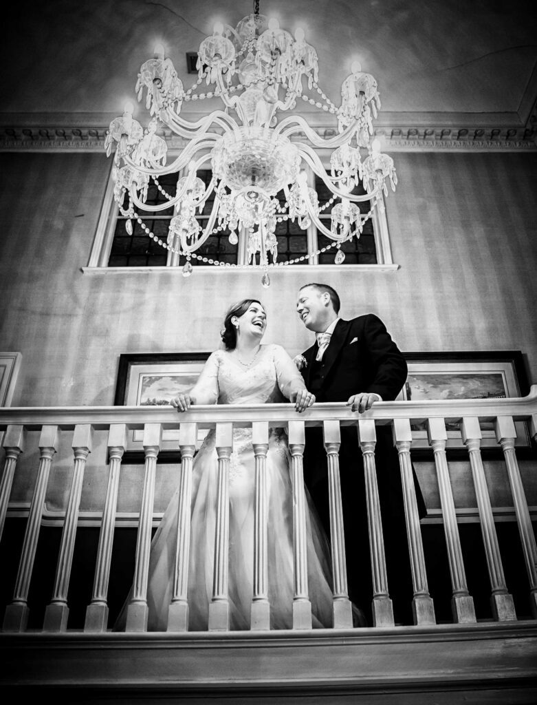 wedding couple by chandelier Hendon Hall London