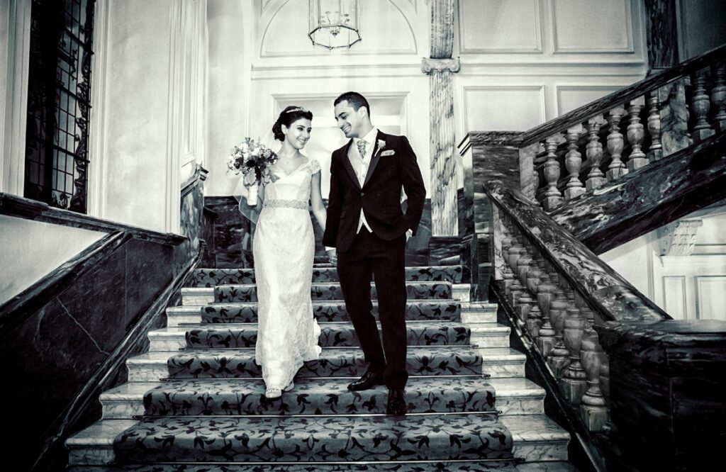 Royal couple walk down stairs at Landmark Hotel wedding