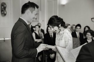 London wedding couple exchanging rings at Asia House photo