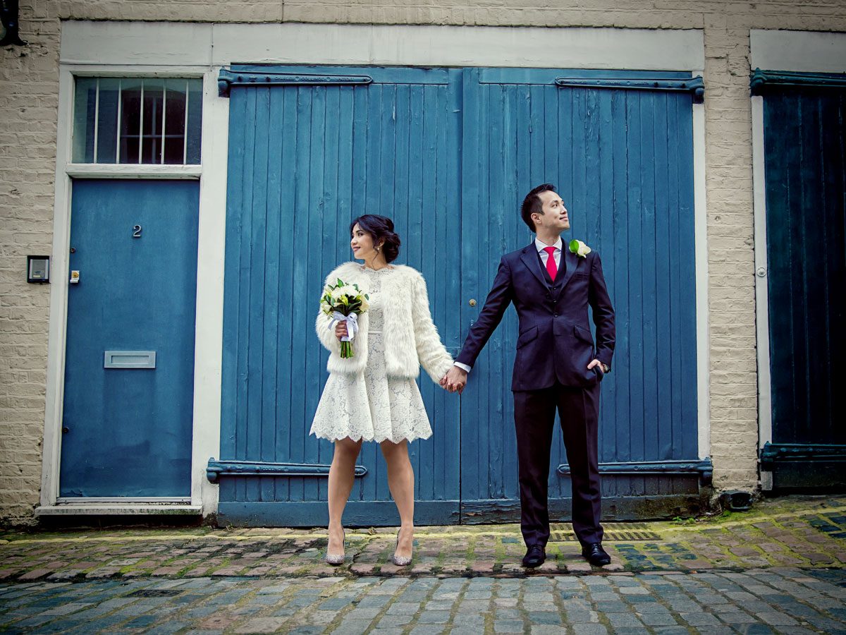wedding couple hold hands in central London mews image