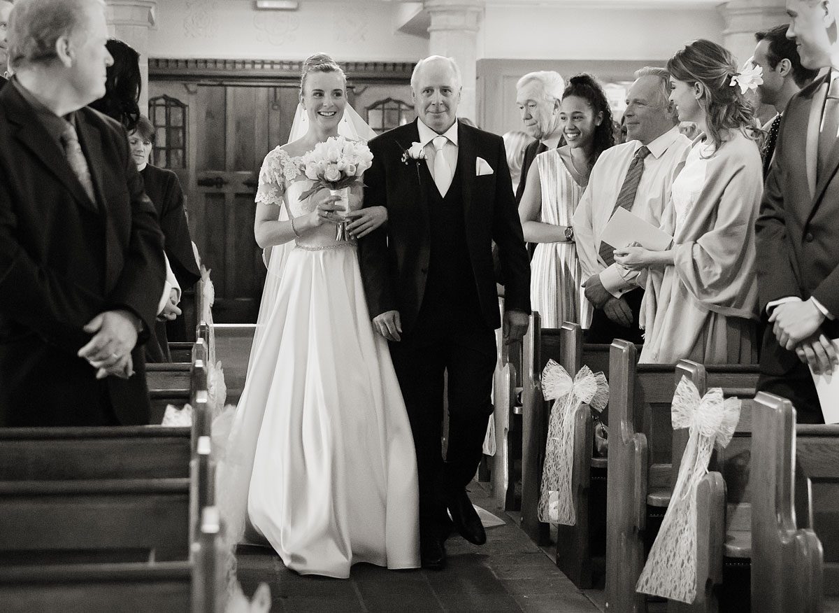 Bride and her father walk down aisle for church wedding