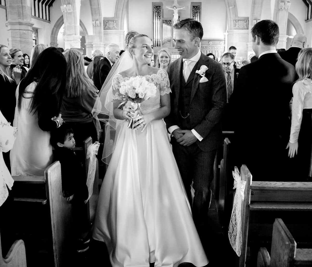 Newly weds walk down church aisle photo