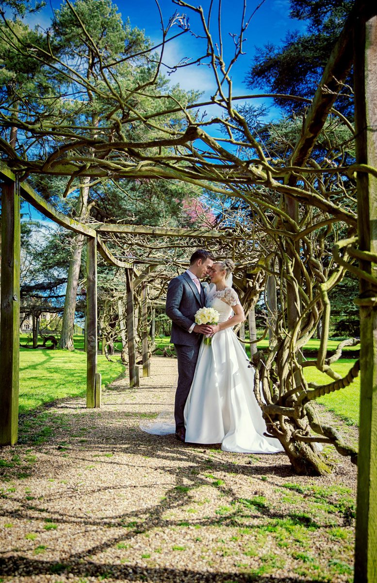 wedding couple head to head in Fanhams Hall orchard image