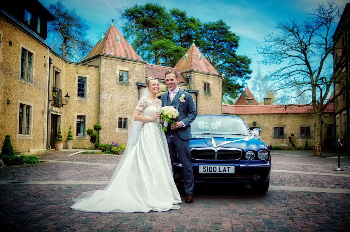 wedding couple with car at Fanhams Hall
