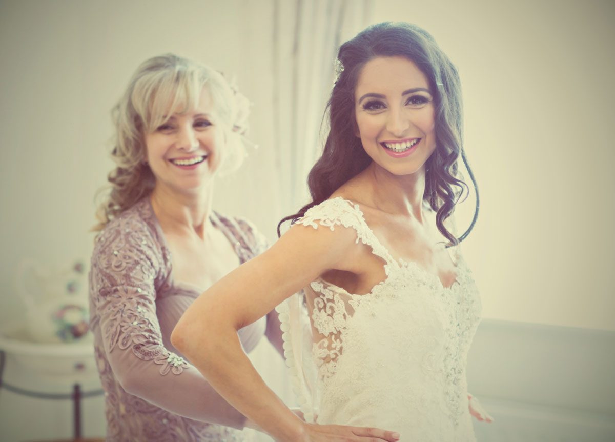 Bride and mother get ready before Italian wedding day image