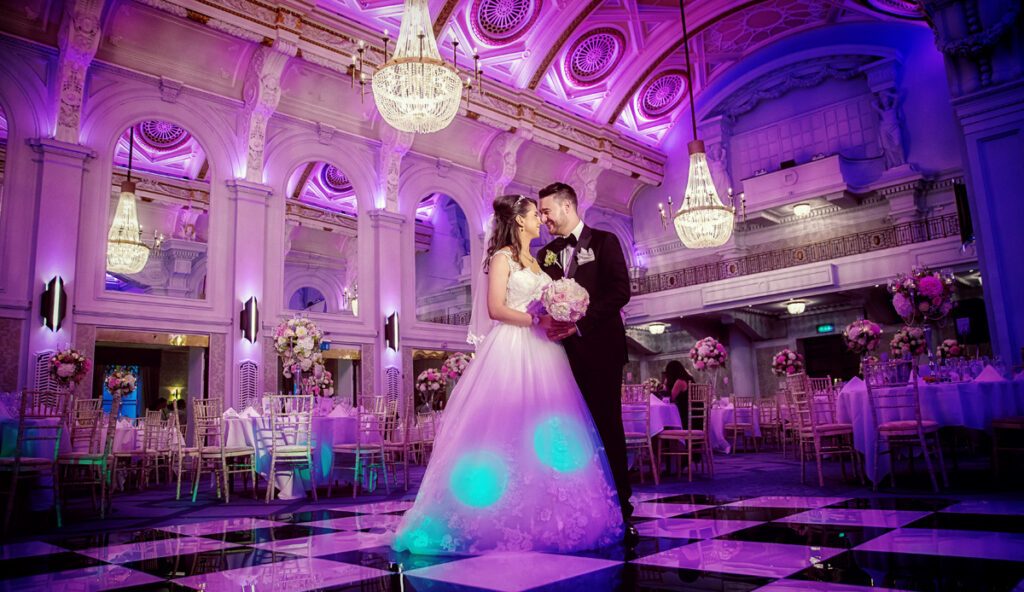 Couple dance and laugh at Connaught Rooms wedding reception