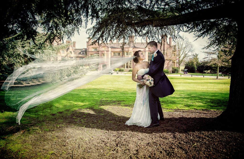 Bride's veil blows in wind at Hanbury Manor wedding Hertfordshire