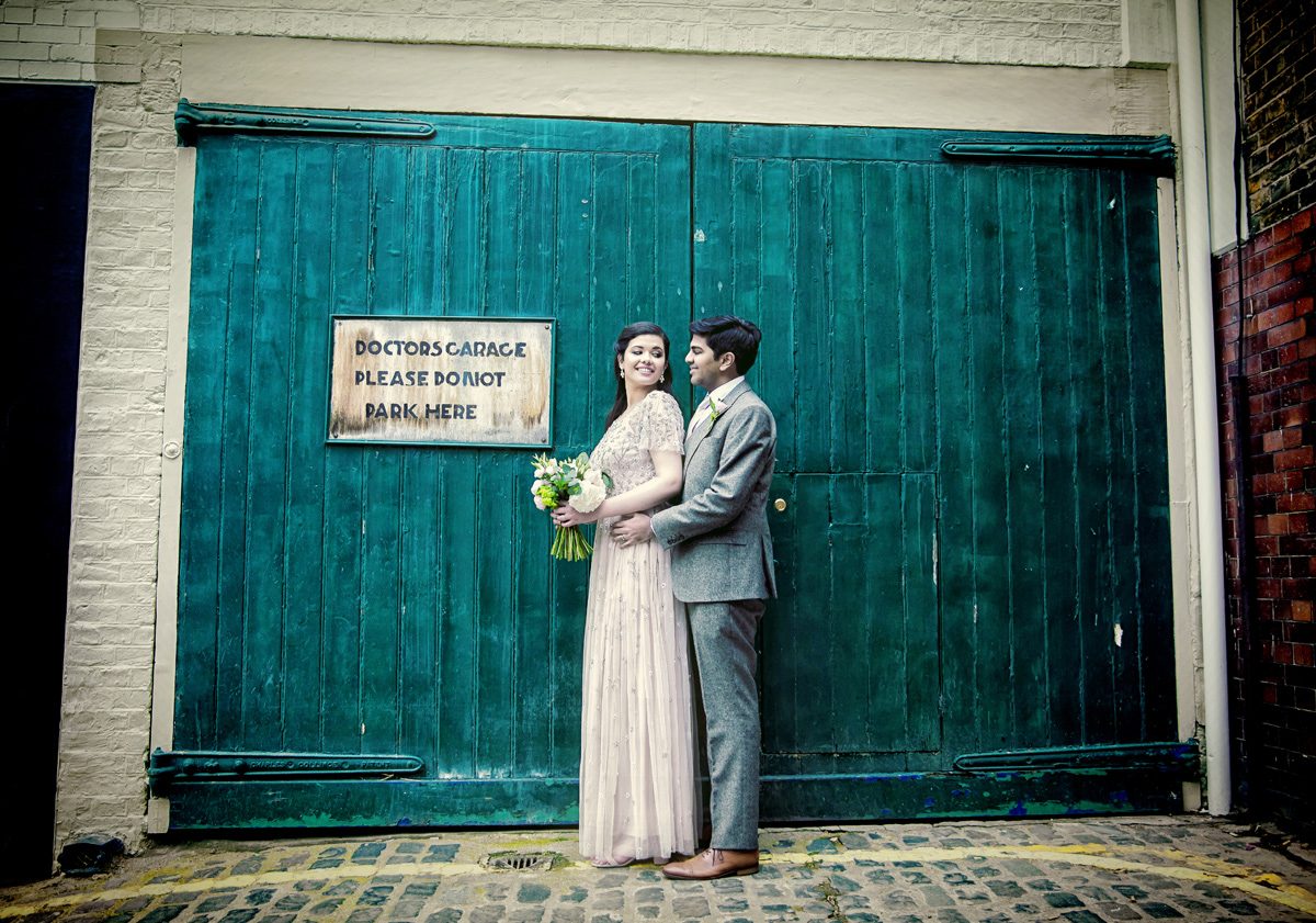 Asia House wedding couple in front of doctor's garage gates