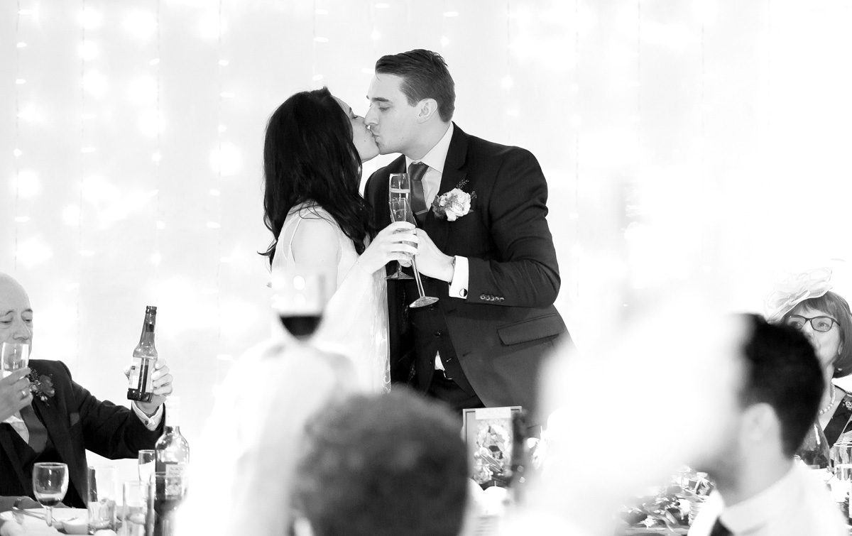 Kiss during wedding speeches at Trinity Buoy Wharf