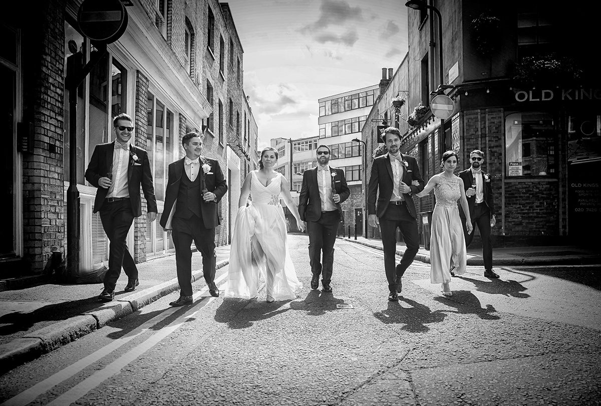 Bridal party walking through Shoreditch wedding streets