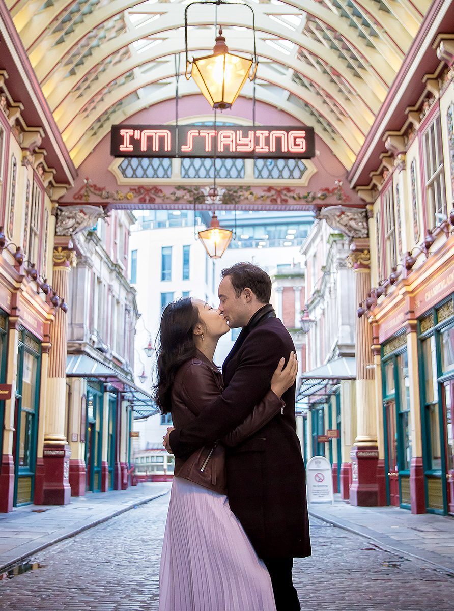 Couple kiss under neon sign Leadenhall Market shoot