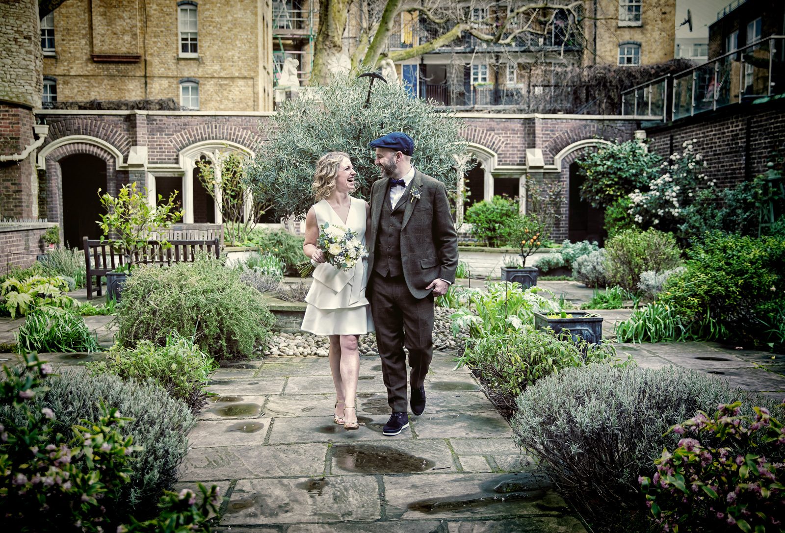 Bride and groom walk through St John's Square gardens London