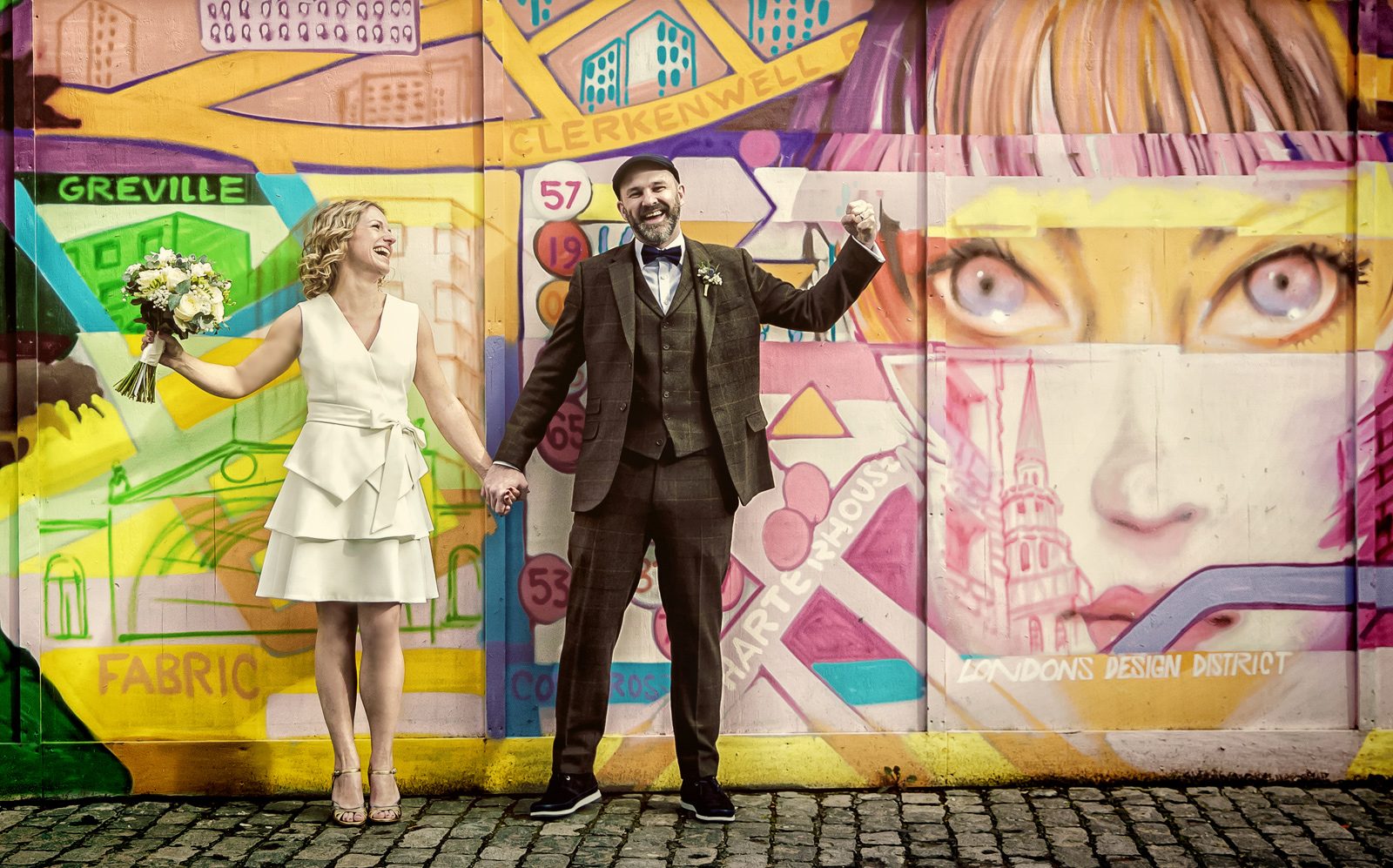 Clerkenwell wedding couple laugh by London graffitti