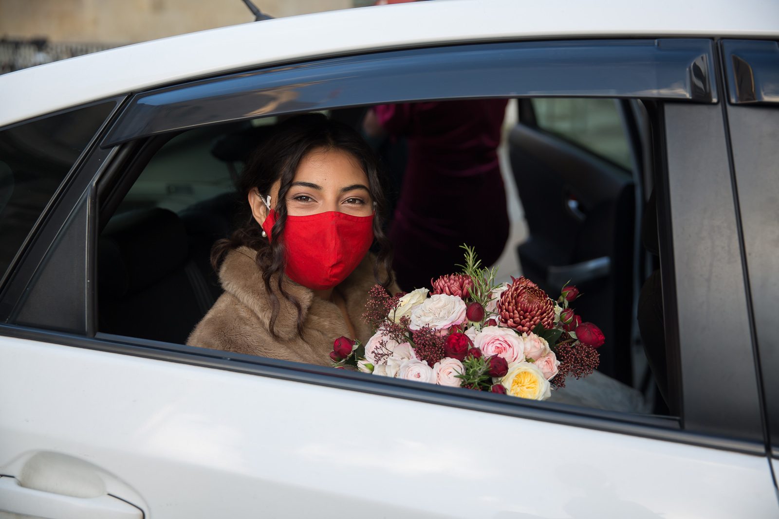 Bride in facemask arrives All Souls wedding London