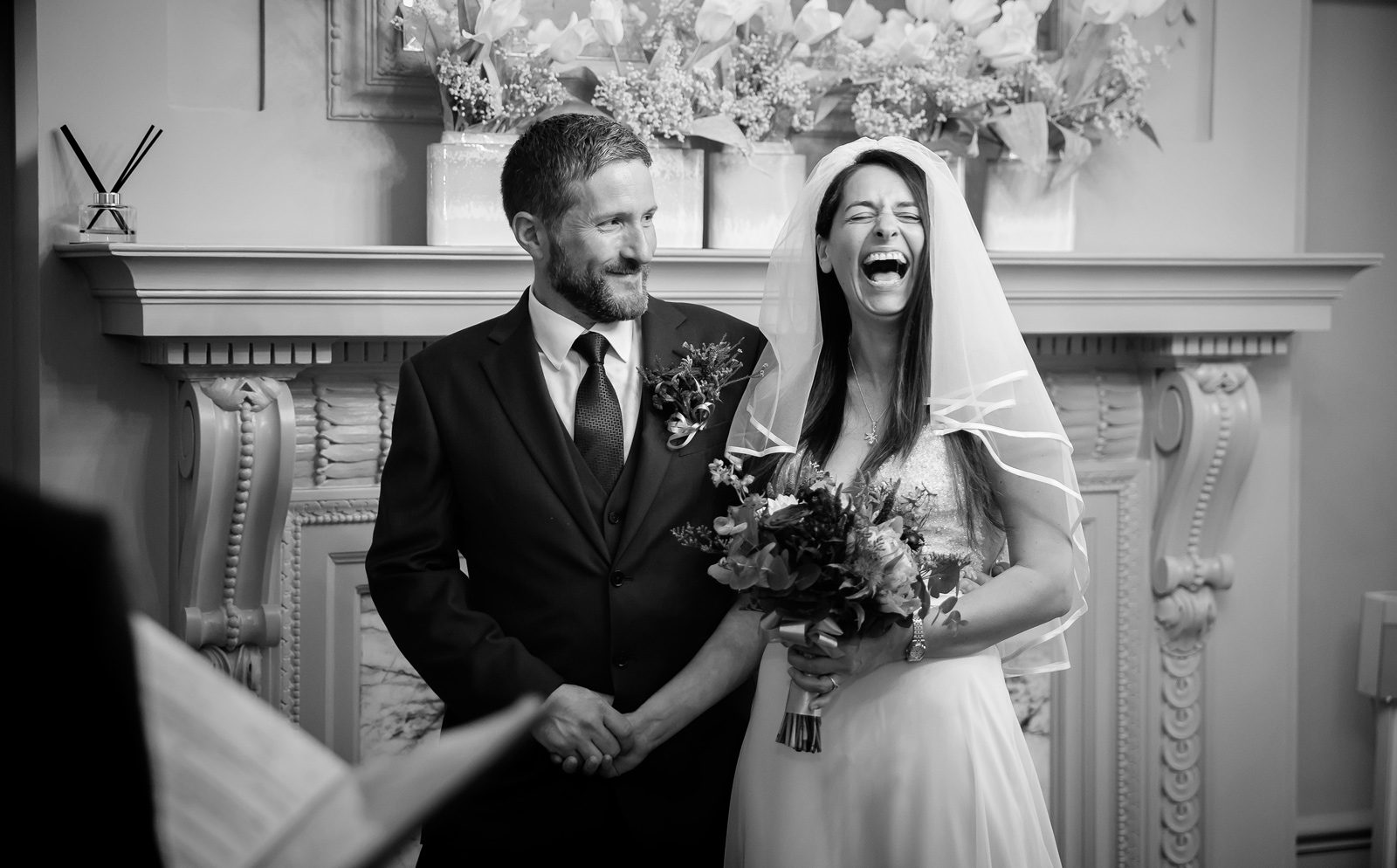 Bride laughs during Old Marylebone Town Hall wedding ceremony
