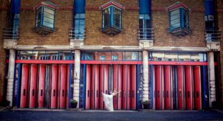 Bride and groom pose outside Islington Fire Station on wedding day