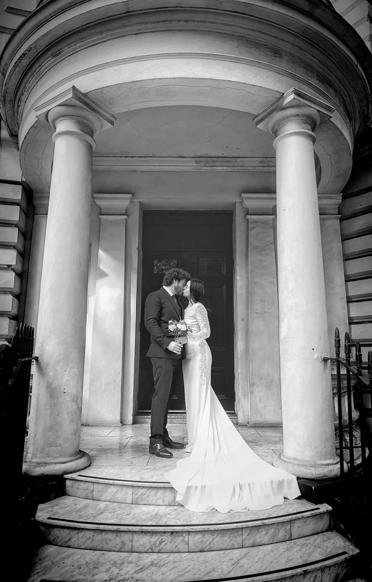 Wedding couple kiss on steps Paddington London