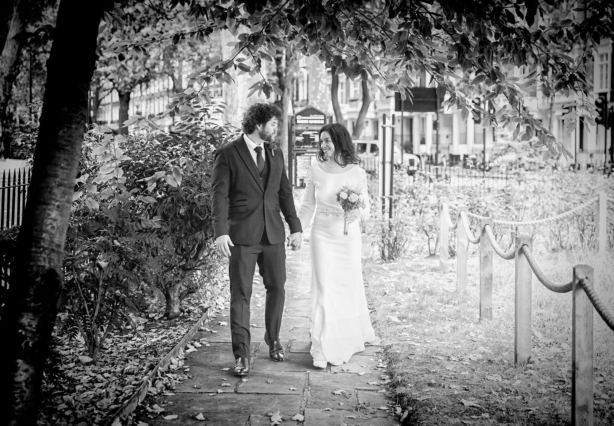Wedding couple stroll through Paddington London park