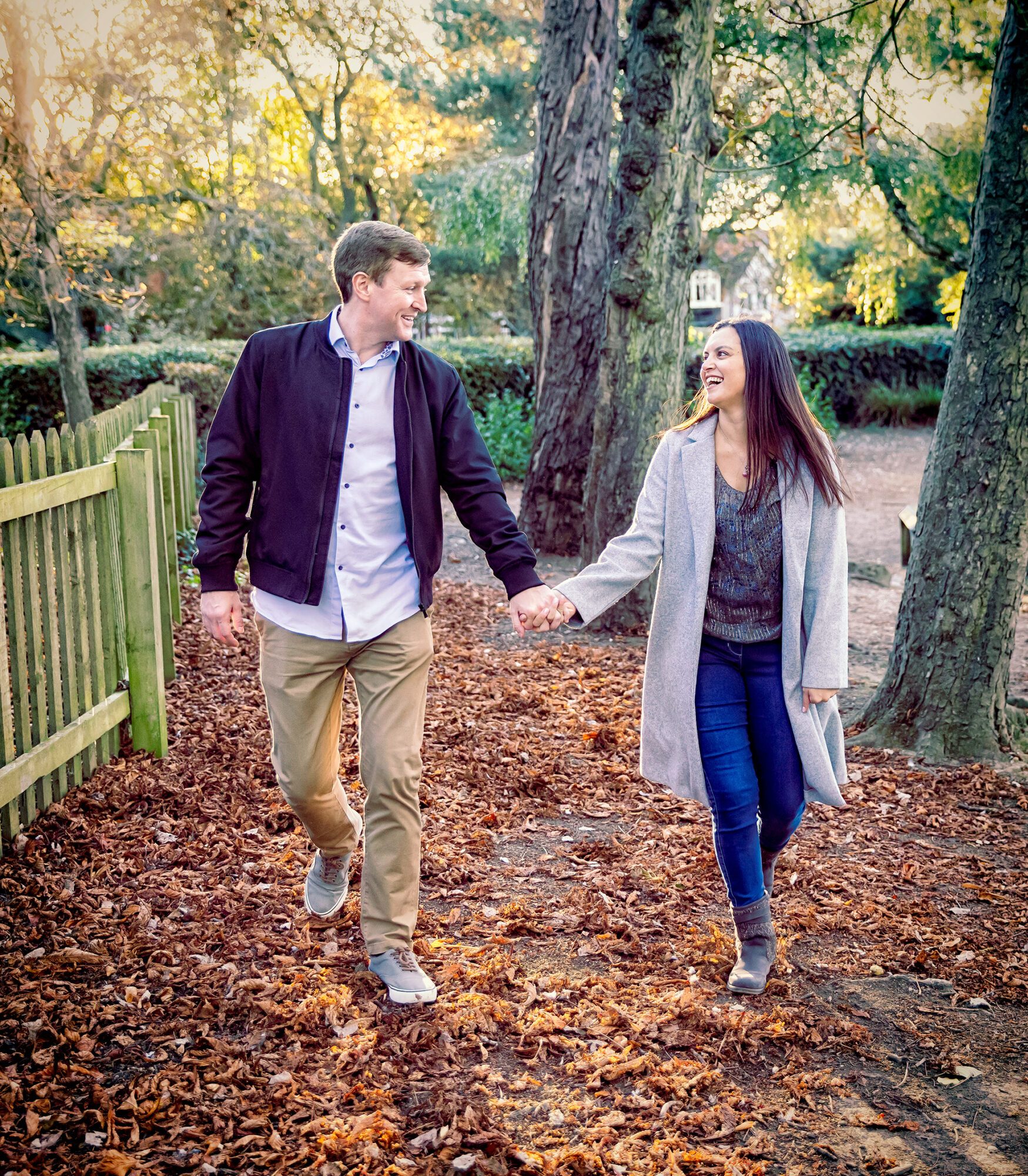 Alexandra Palace engagement shoot, couple walk through leaves