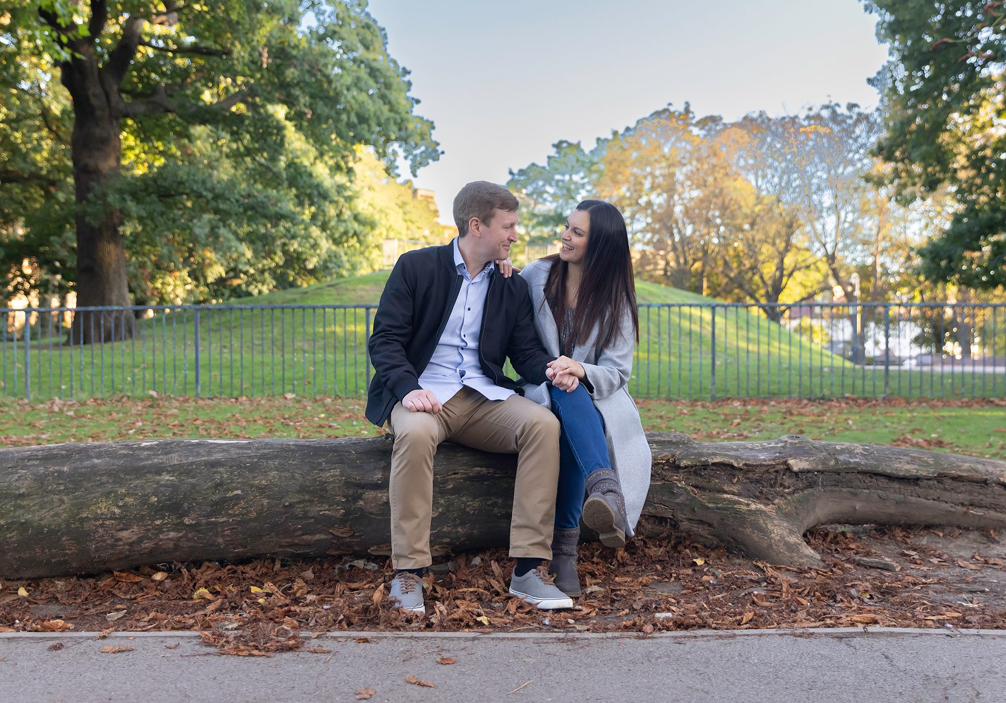 Couple sat on log Alexandra Palace engagement photo shoot