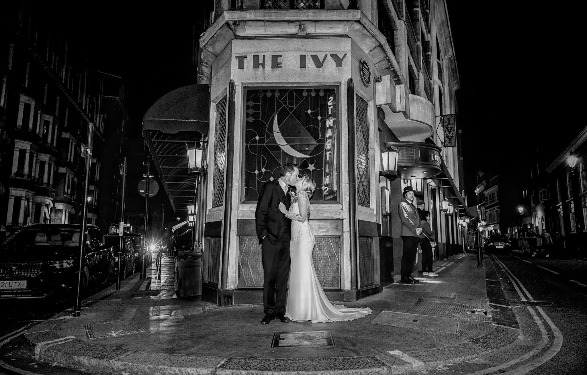 Wedding couple kiss outside The Ivy central London image