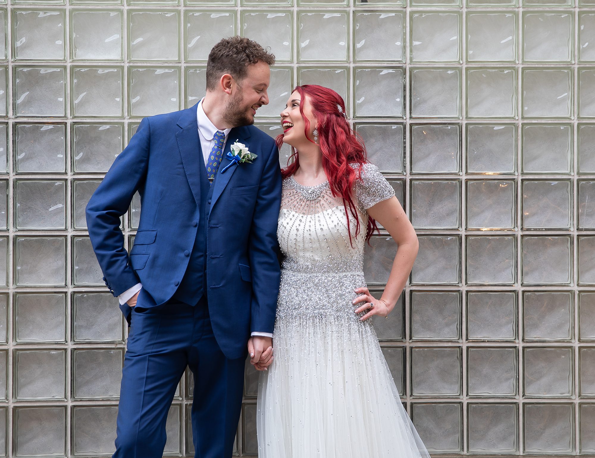 Islington wedding couple laughing by glass wall Upper Street London